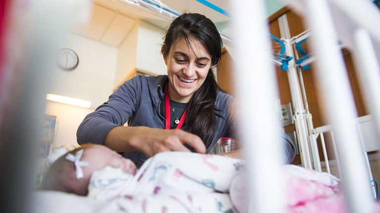 A nurse cares for a newborn baby