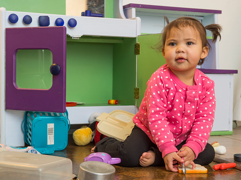 Amara, biliary atresia patient at Children's Hospital Colorado, plays in a toy kitchen.