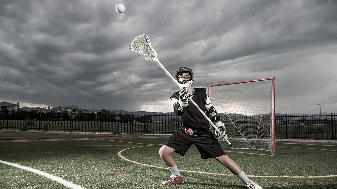 A lacrosse player catches the ball