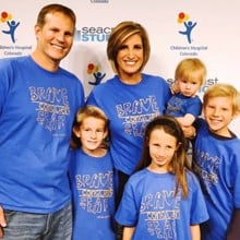 A family wearing Brave Conquers Fear shirts at a Children's Hospital Colorado event.