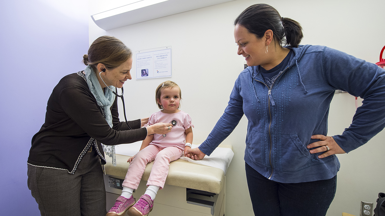 Pediatric hepatologist Dr. Cara Mack examines a young patient at Children's Hospital Colorado.